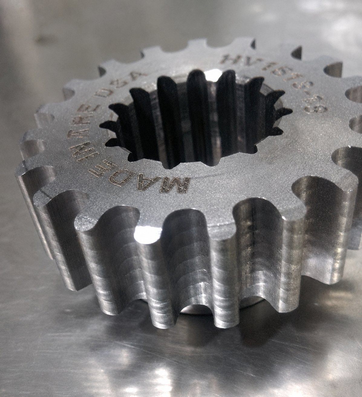 KNS gear-hobbed snowmobile chaincase gear with a clean, polished involute tooth form, made in the USA