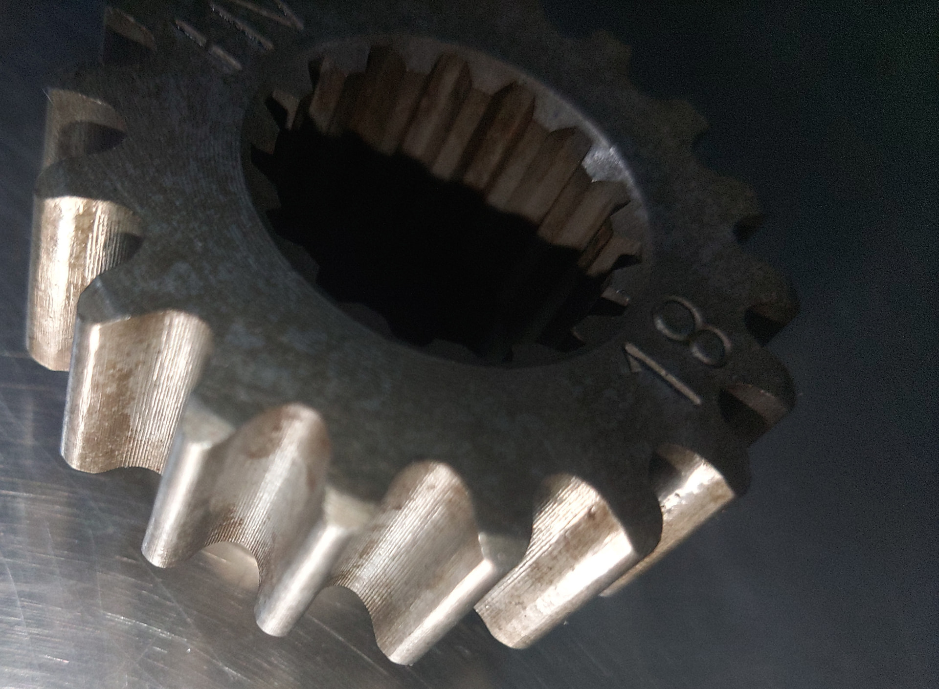 Competitor EDM-cut chaincase gear showing a rough, recast tooth surface